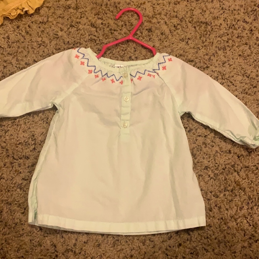 Pale blue top with floral detail. Carter’s. 3 mo.